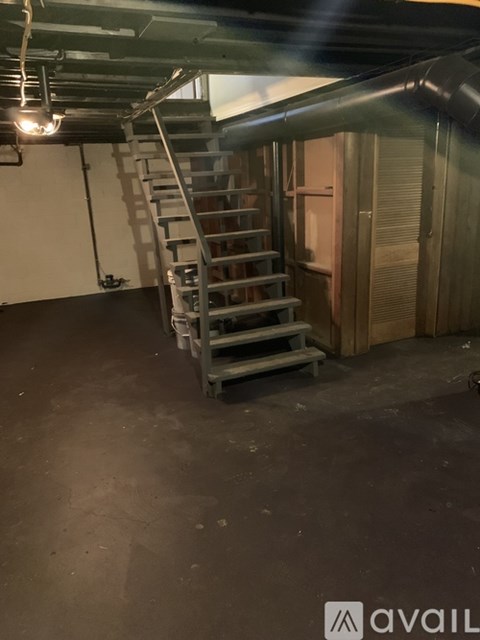 A staircase in a room with a concrete floor.