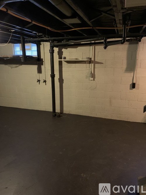 A room with white walls and a concrete floor.