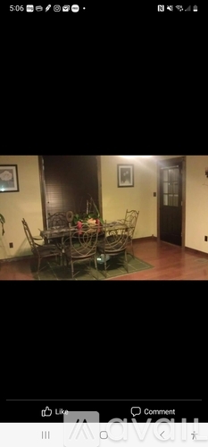 A room with a table and chairs.