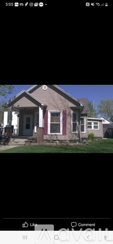 A house with a red door and a small porch.