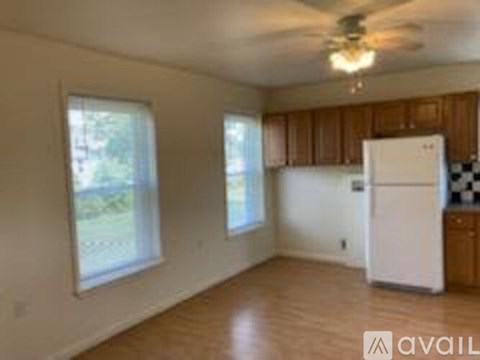 A kitchen with wooden cabinets and a white refrigerator.