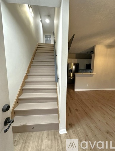 A two-story house with a garage is situated in a residential area.