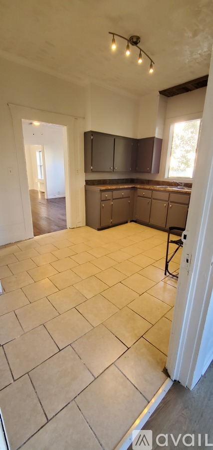 A kitchen with tile flooring and a countertop.