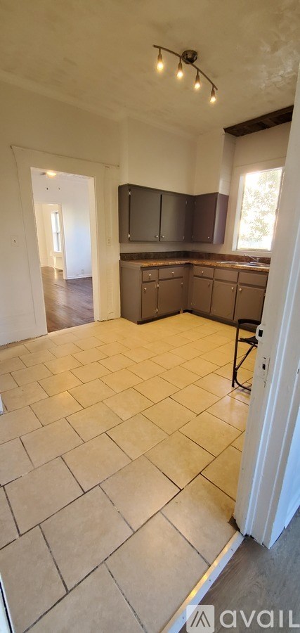 A kitchen with tile flooring and a countertop.