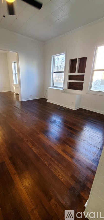 A room with wooden floors and white walls.