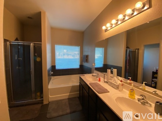 A bathroom with a large mirror and a bathtub.