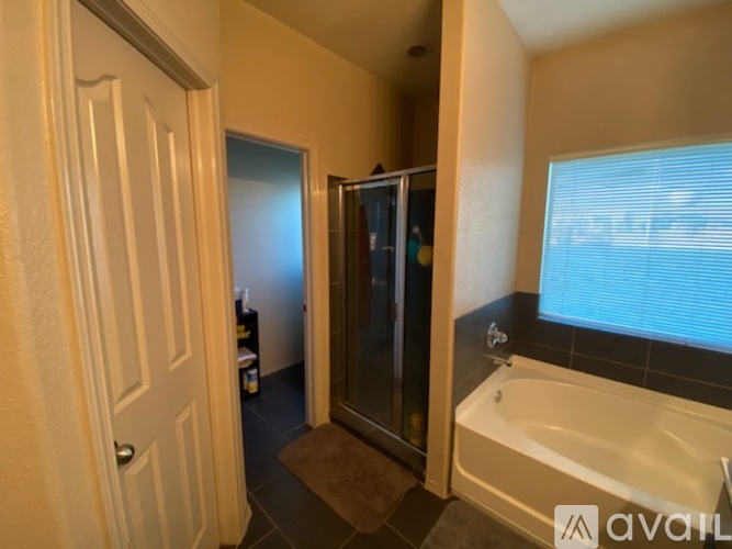 A bathroom with a tub, toilet, and sink.