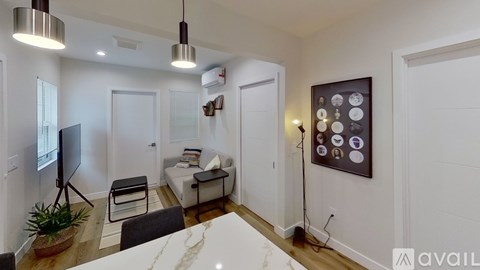 A modern living room with a white couch and a television.