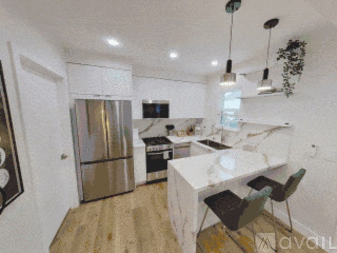 A kitchen with a refrigerator, stove, and sink.