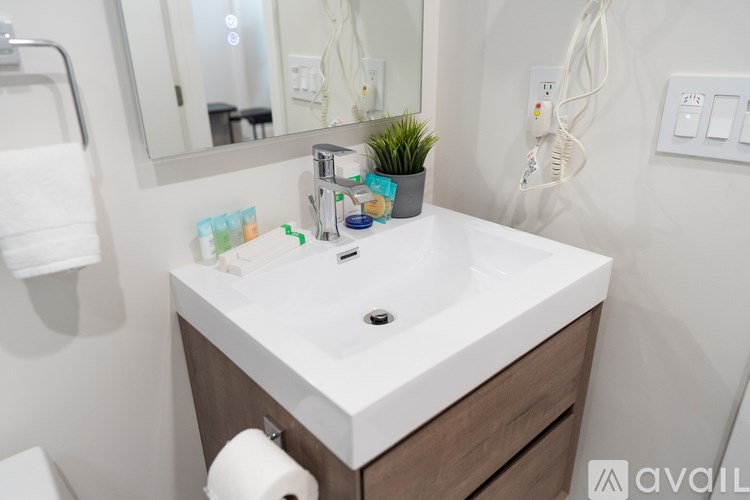 A white sink in a bathroom with a mirror above it.