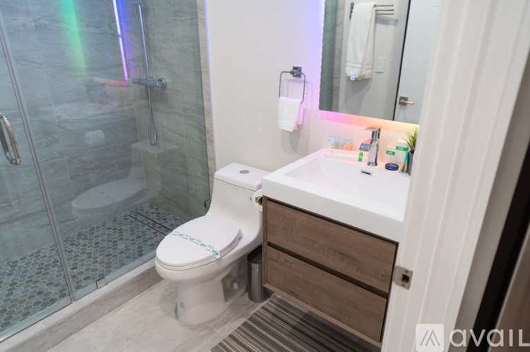 A white toilet with a white tank in a bathroom.