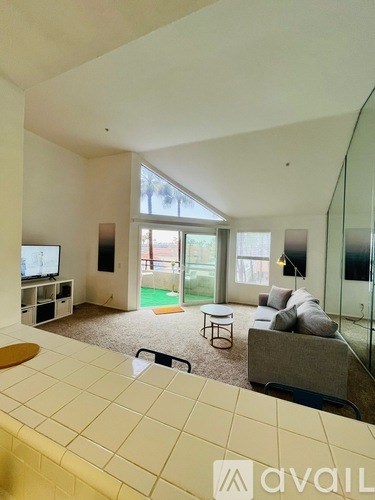 A living room with a television and a couch.