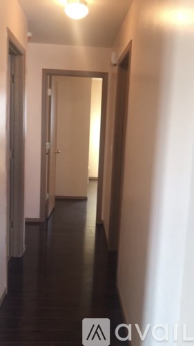 A hallway with a door at the end.
