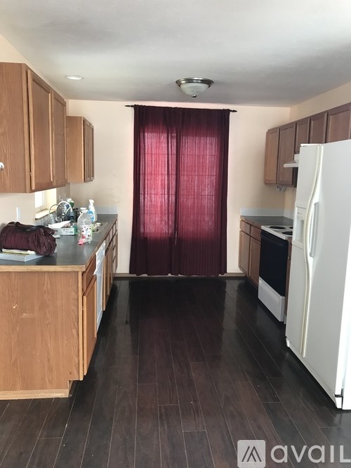 A kitchen with wooden cabinets and a white refrigerator.