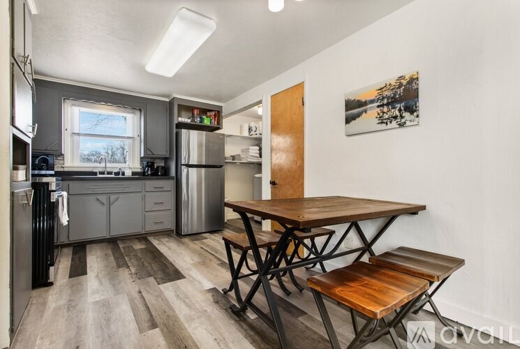 A kitchen with a table and chairs in the middle of the room.