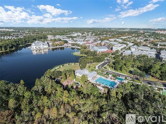 A bird's eye view of a city with a large body of water and a swimming pool.
