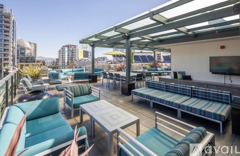 A patio with blue chairs and a white table.