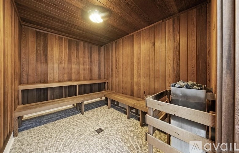 A room with wooden walls and a bench.