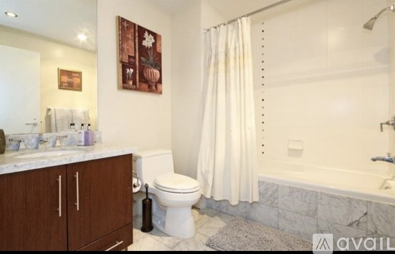 A bathroom with a toilet, sink, and bathtub.