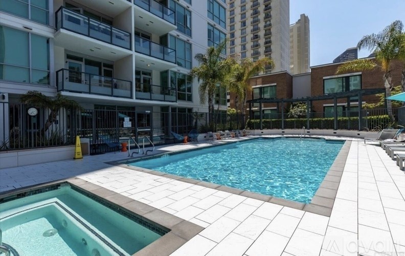 A large outdoor swimming pool with a smaller pool in the middle of it.