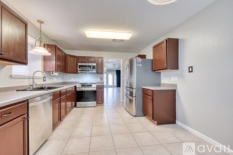 A kitchen with brown cabinets and a white countertop.