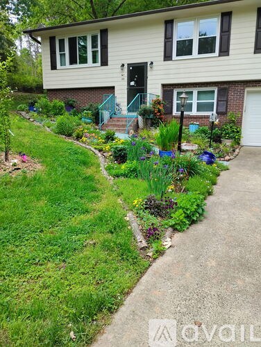 A house with a green lawn and a garden in front.