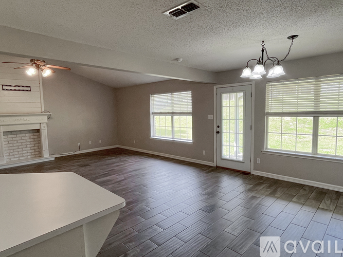 A spacious room with a fireplace and a dining table.