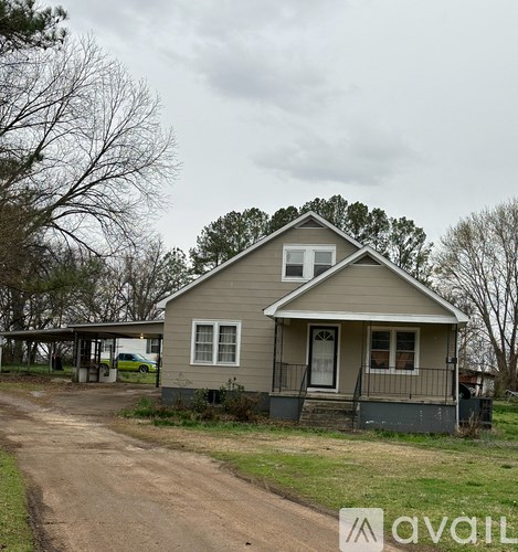 A house with a grey roof and a white door is available for sale.