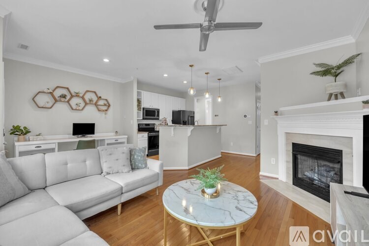 A white desk with a green chair and a white shelf underneath it.