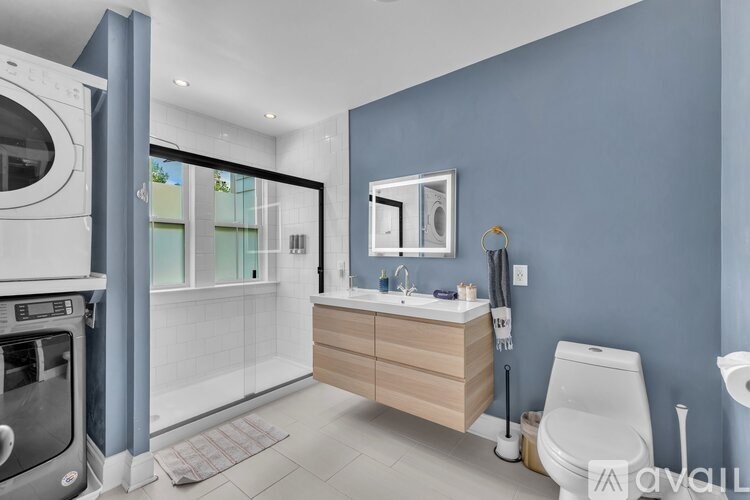 A room with a desk and chairs with a balcony outside.