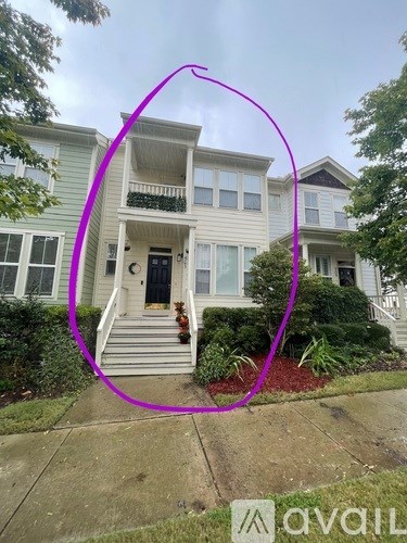 A house with a front yard and a porch.