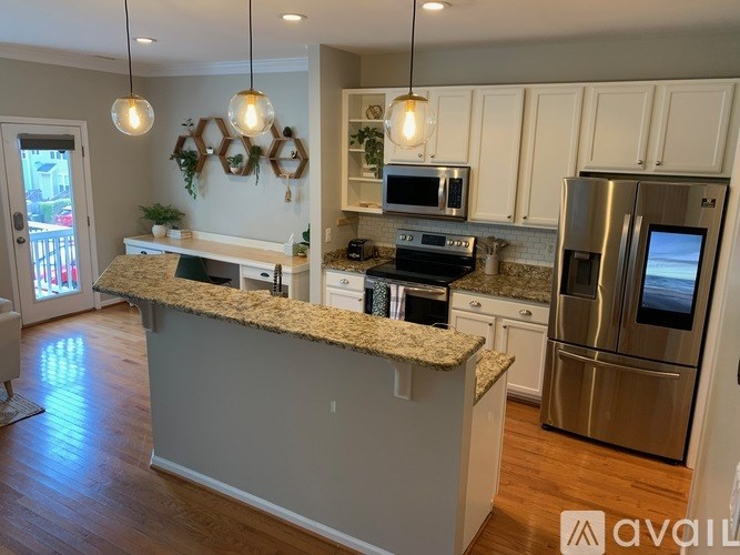 A kitchen with granite countertops and stainless steel appliances.