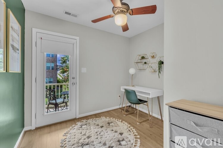 A room with a desk and a chair in it.