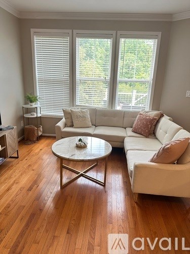 A living room with a white couch and a coffee table.