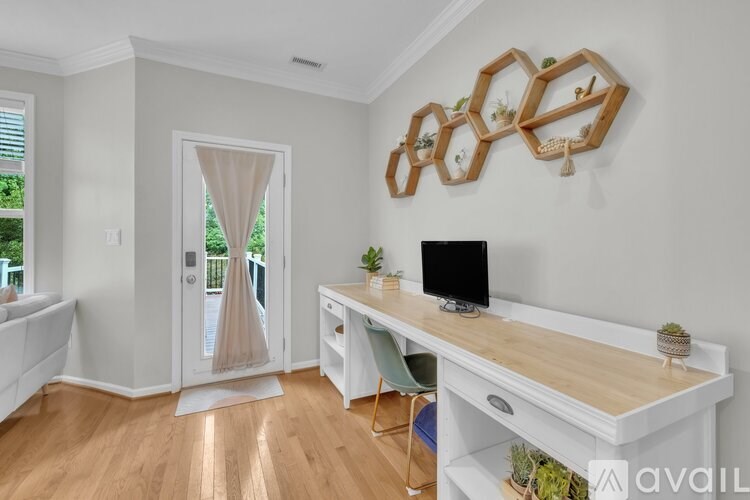 A bathroom with a toilet, sink, mirror, and lighting.