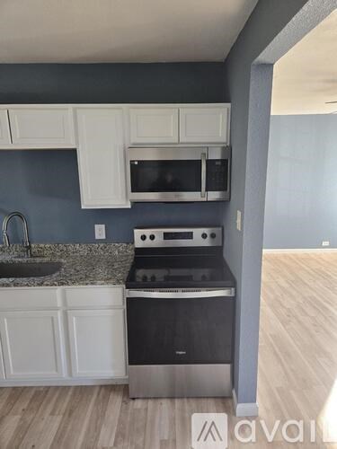 A kitchen with a stove, oven, and microwave.