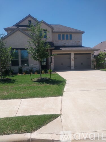A house with a garage and a driveway.