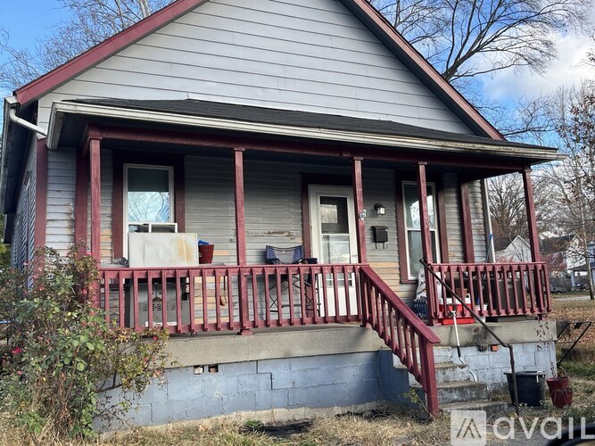 A small house with a red porch.