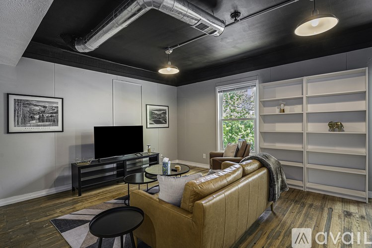 A living room with a brown couch and a television.