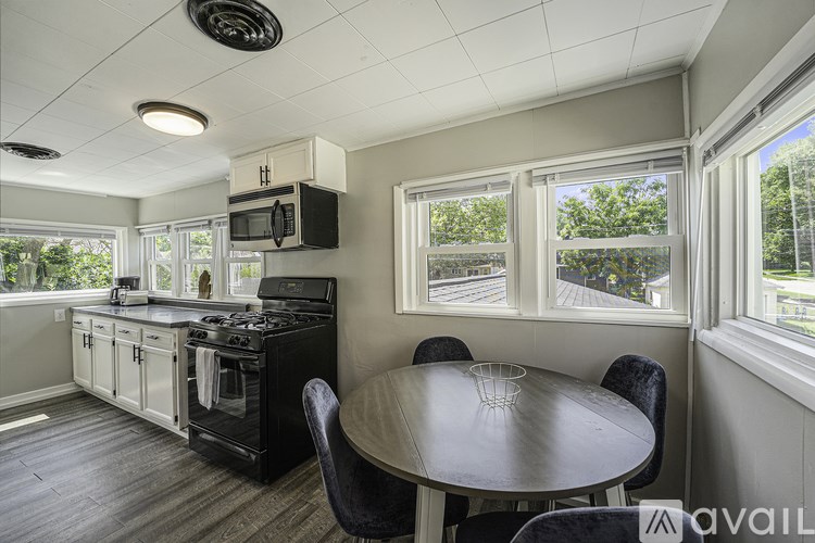 A kitchen with a table and chairs and a window.