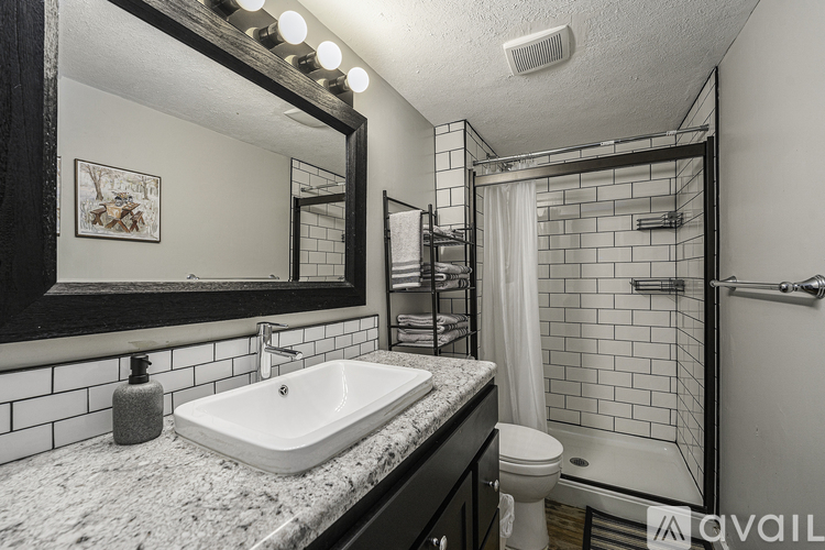 A bathroom with a sink, mirror, and toilet.