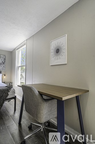 A room with a desk and chair in it.