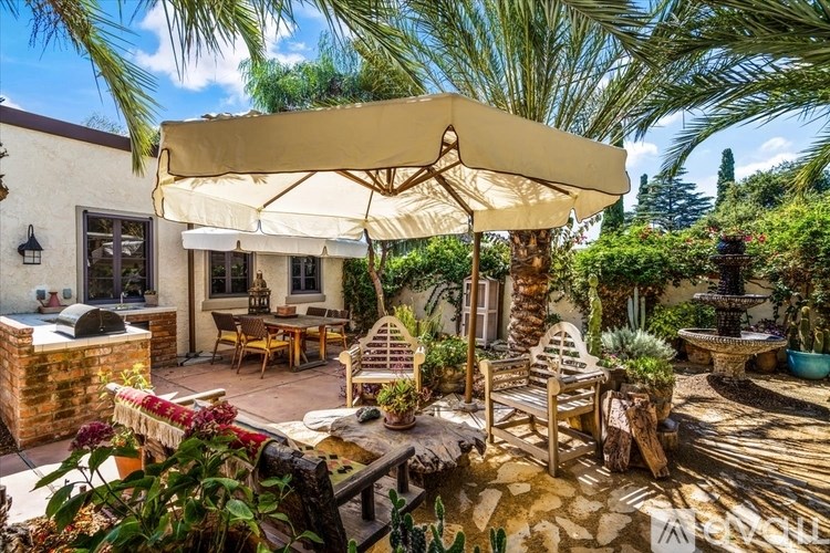 A patio with a table and chairs under a canopy.