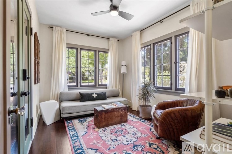 A living room with a couch, chair, and rug.