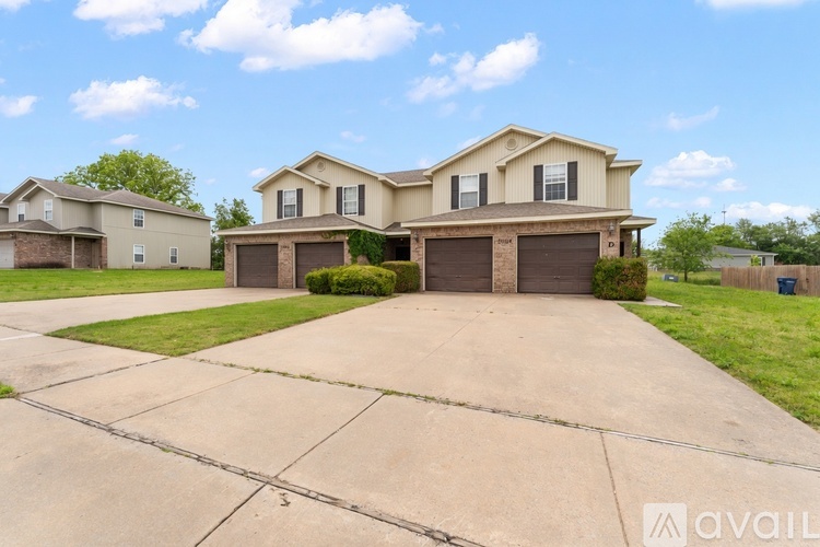 A two-story house with a garage on the lower level.