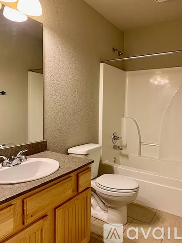 A bathroom with a toilet, sink, and bathtub.
