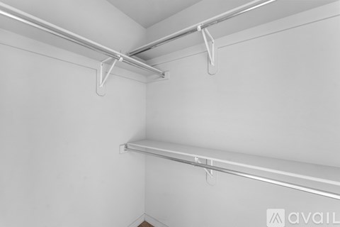 A room with a ceiling fan and a door.