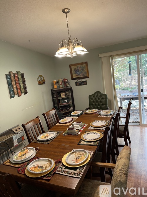 A dining room with a long table set for a meal.