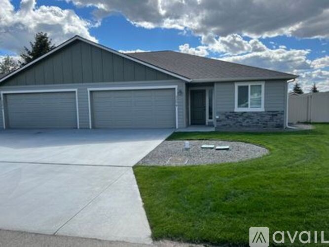 A two-car garage with a stone pillar in front of it.