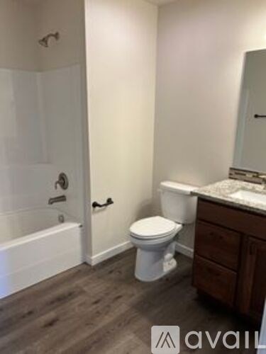 A bathroom with a toilet, sink, and bathtub.